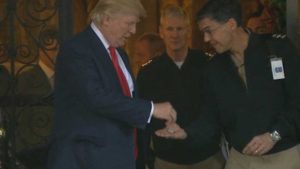 President Trump gives a custom trump challenge coin to military service members