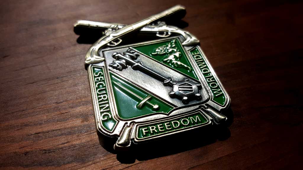 army challenge coin front image showing guns